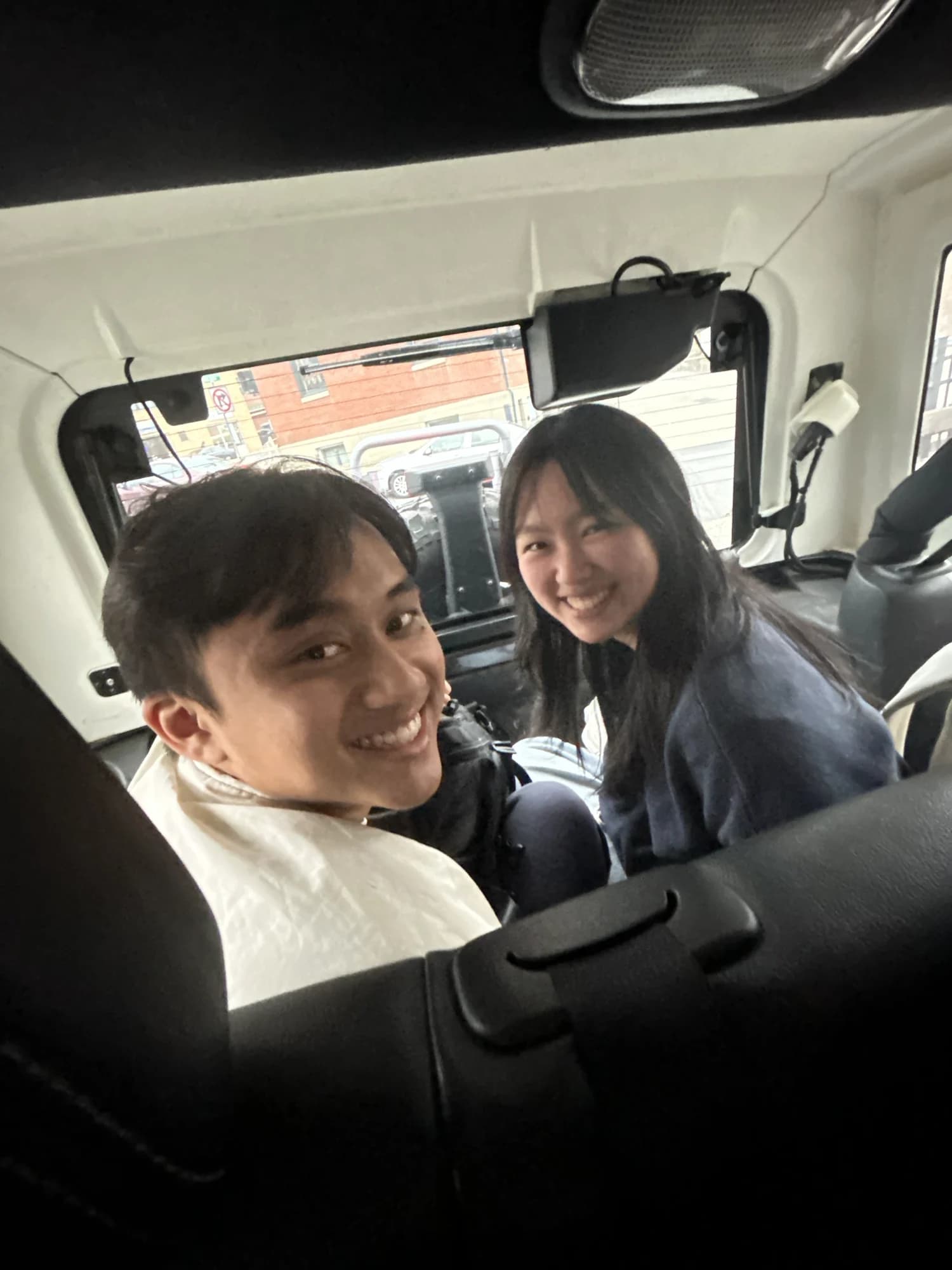 Two members turned around from the front seats of a car