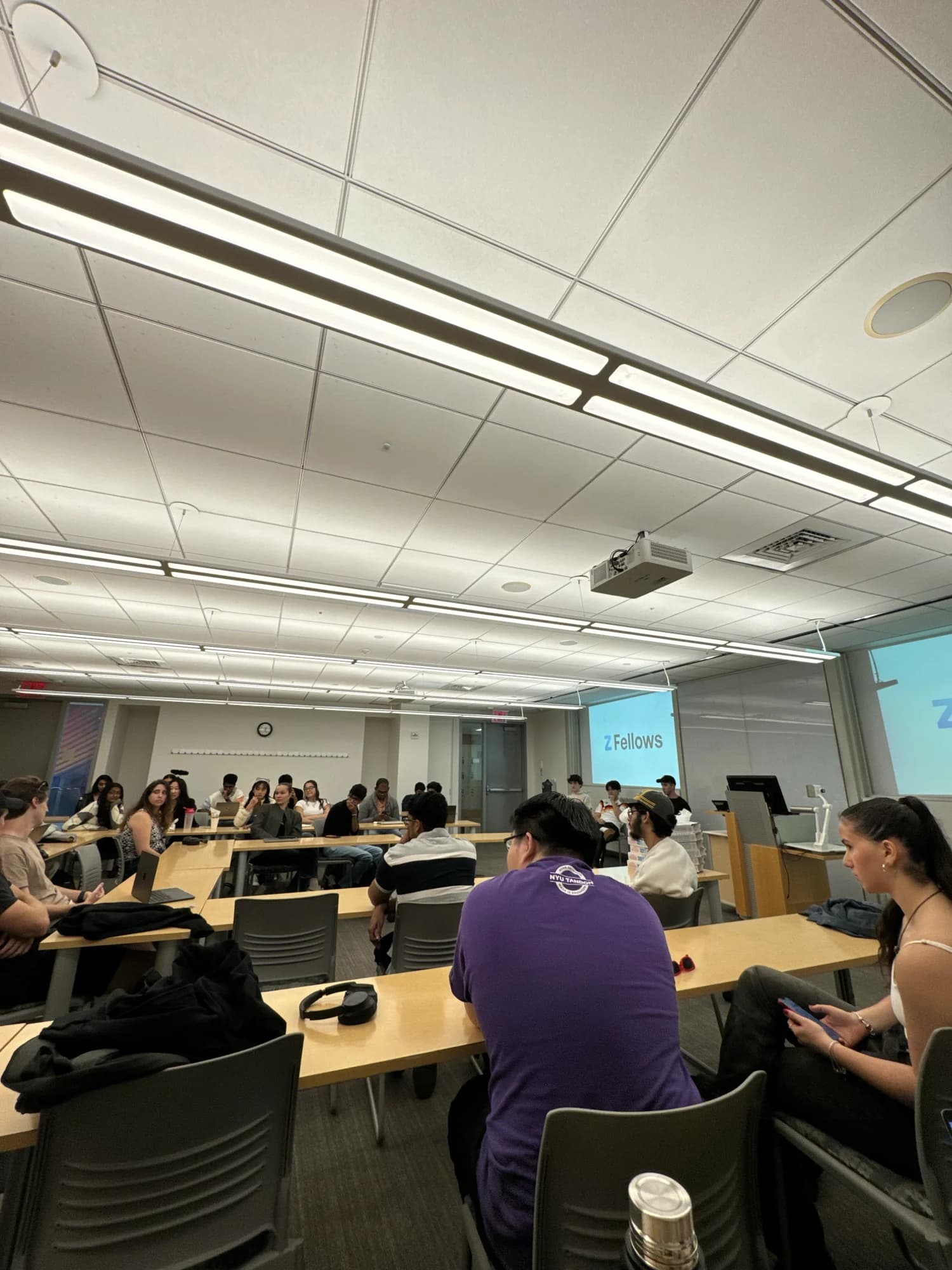 A full classroom during a session, a Z Fellows slide on the screen