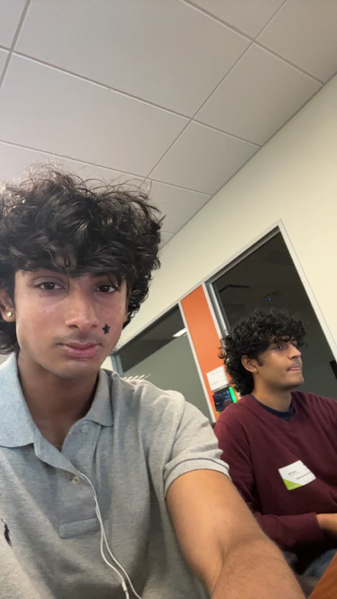 A selfie of two members in a classroom before a session