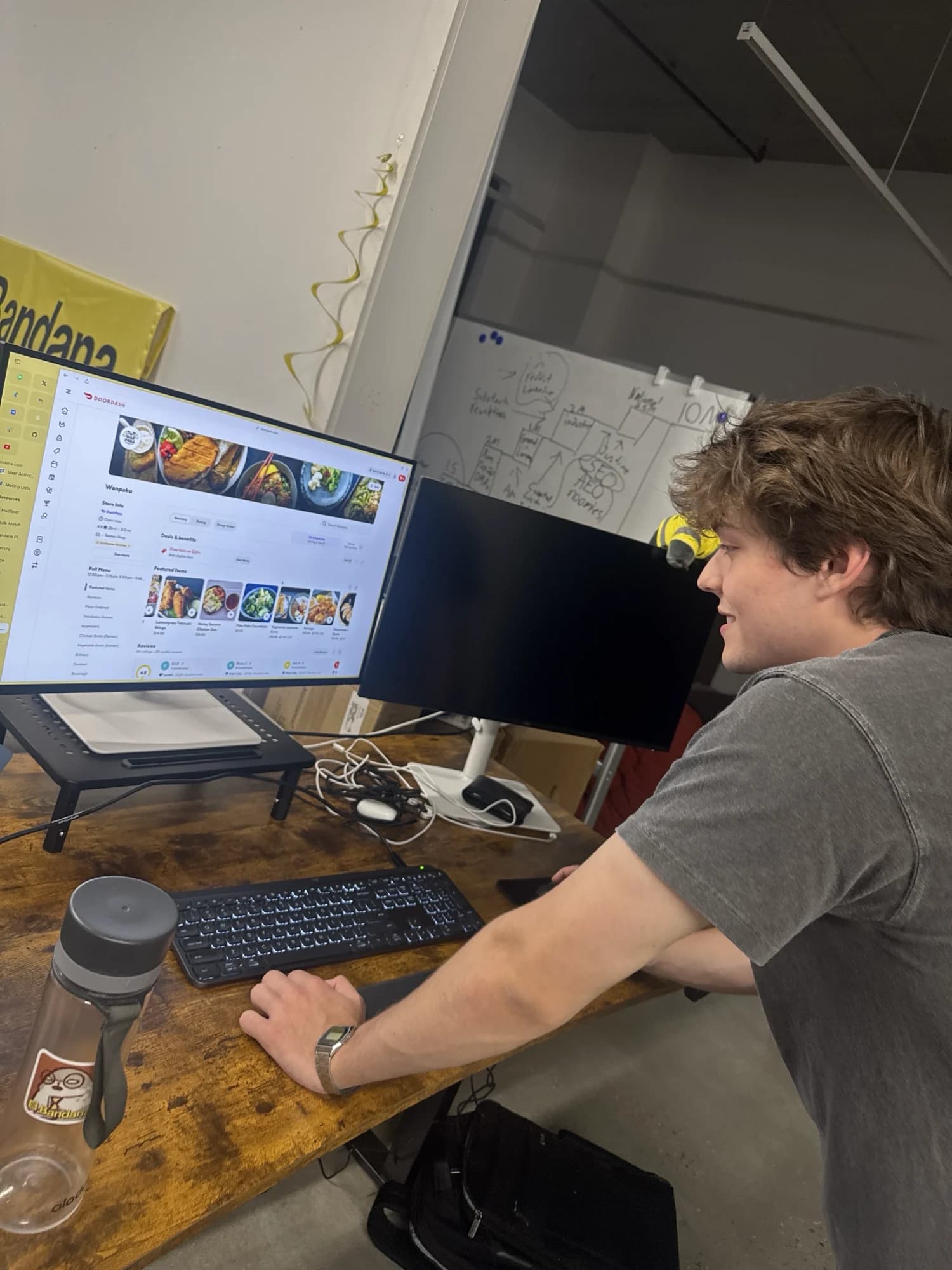 A member at a standing desk working on a food-delivery app