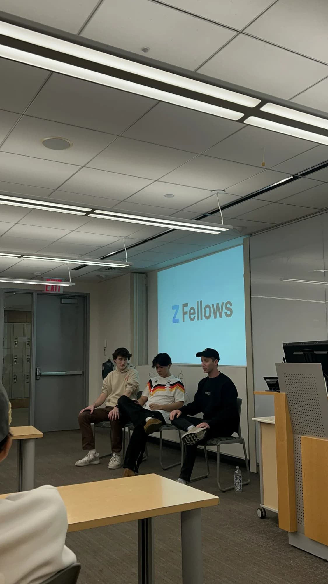Three members on a panel in front of a Z Fellows slide
